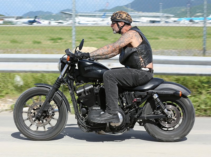 Tough biker riding Harley
